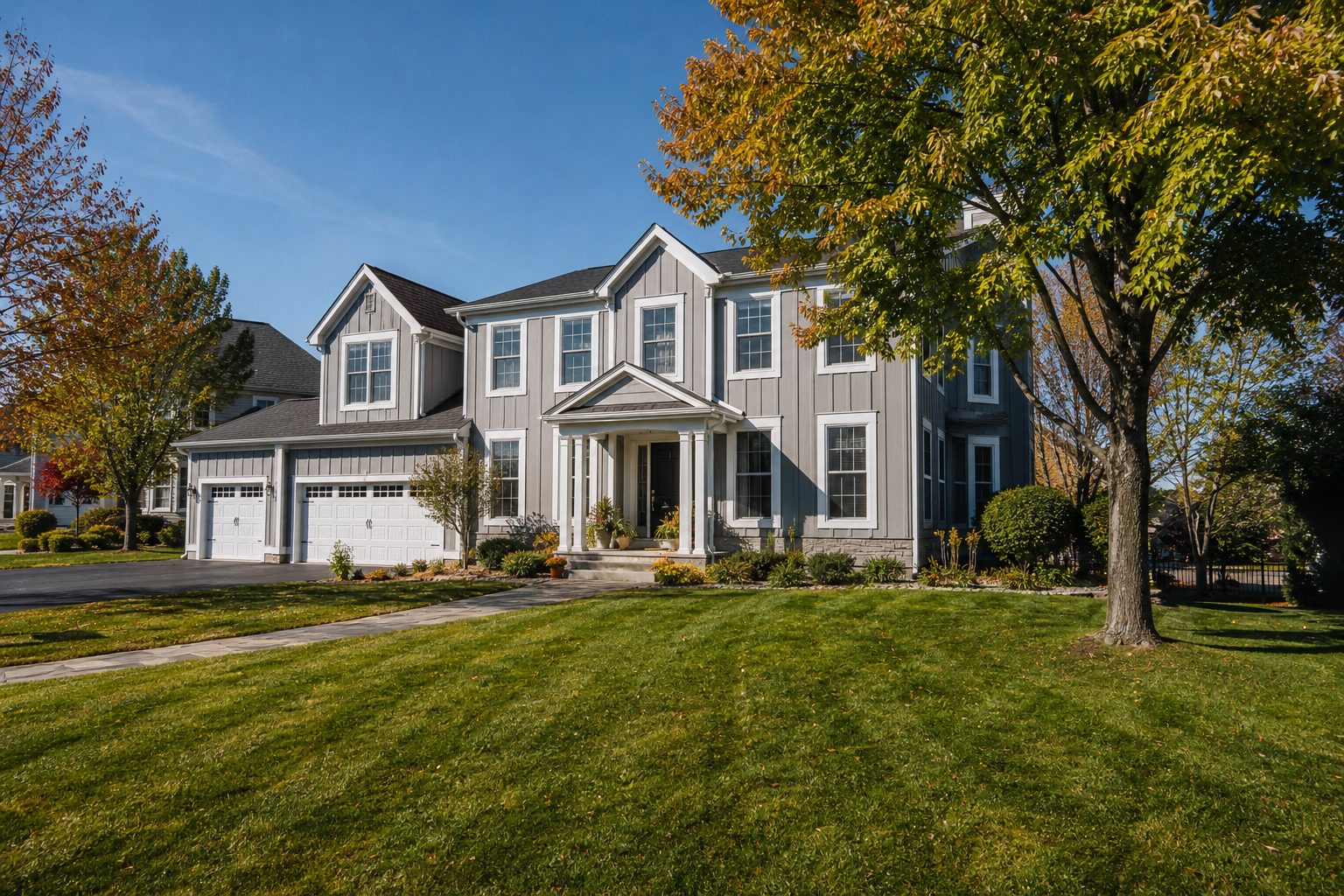 Two-story colonial home with mature trees and established lawn in West Madison new construction area near Middleton.