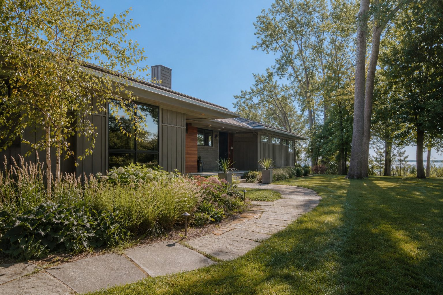 Contemporary lakeside ranch home with natural cedar siding and mature trees near Lake Waubesa in McFarland.