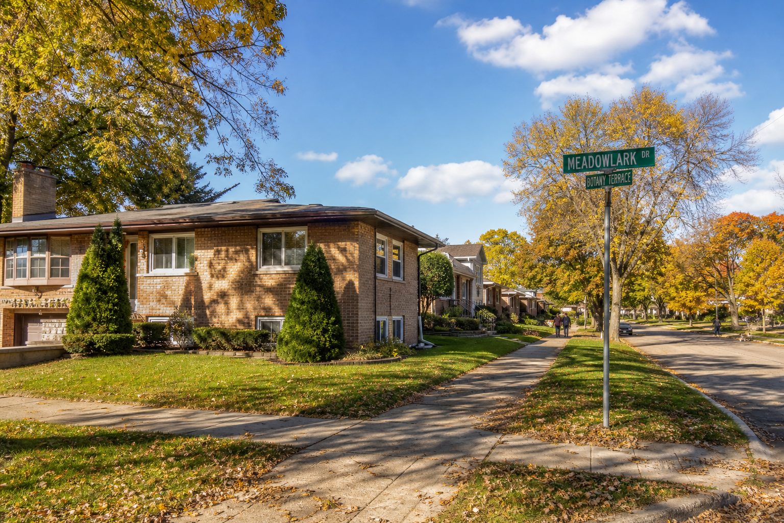 Split-level neighborhood scene on Meadowlark Drive in Rolling Meadows with residents walking, mature trees, and Kennedy Park visible.
